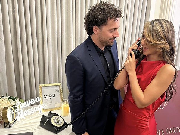 a couple using an audio guest book at a wedding